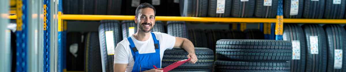 Mechanic sorting through tyres - Tyres Swindon